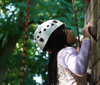 Camper climbing a rock wall